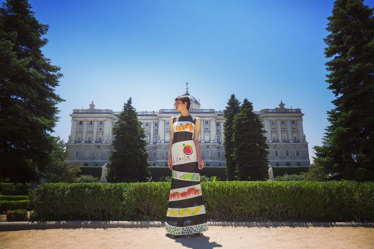 A model in a hand-painted Chula column dress in the gardens of the Royal Palace of Madrid