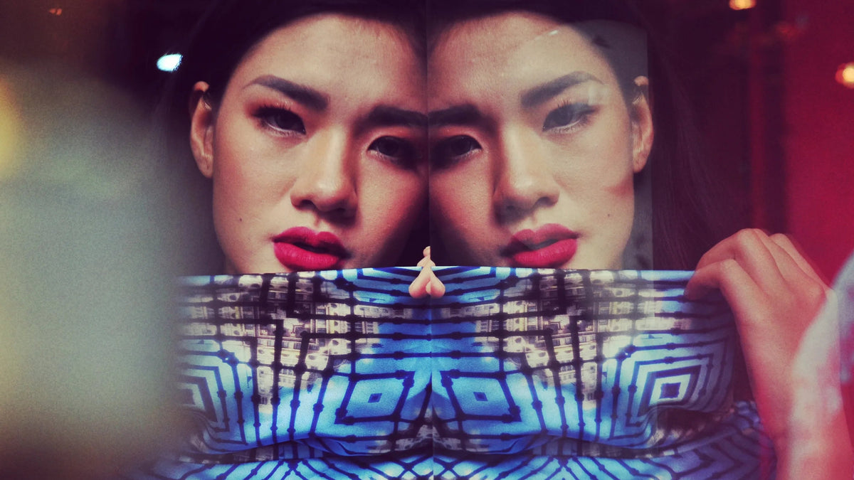 Portrait of a model mirrored above a hand-painted geometric band