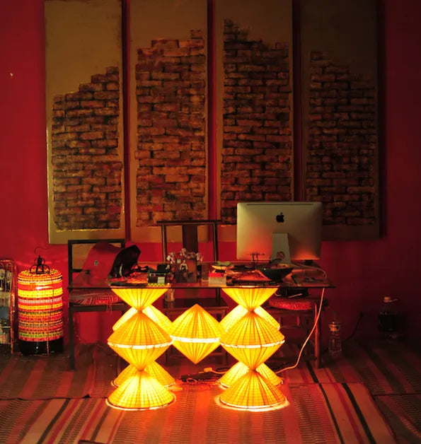 The Chula workshop interior in Hanoi, lit by woven lamps