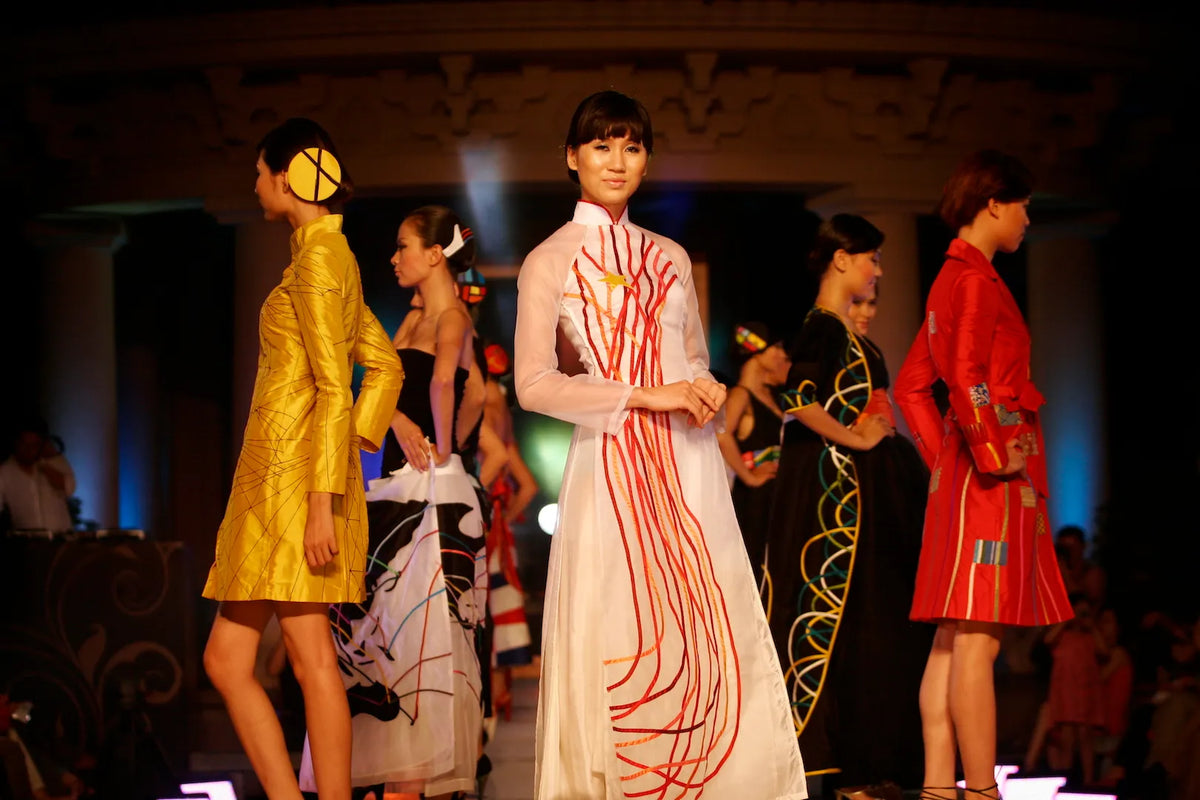 Models in hand-painted ao dai from The World collection, 2007