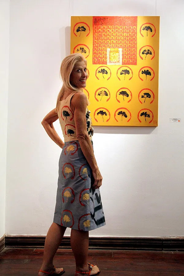 A visitor in a Chula dress beside a yellow artwork at Art Vietnam Gallery, 2009