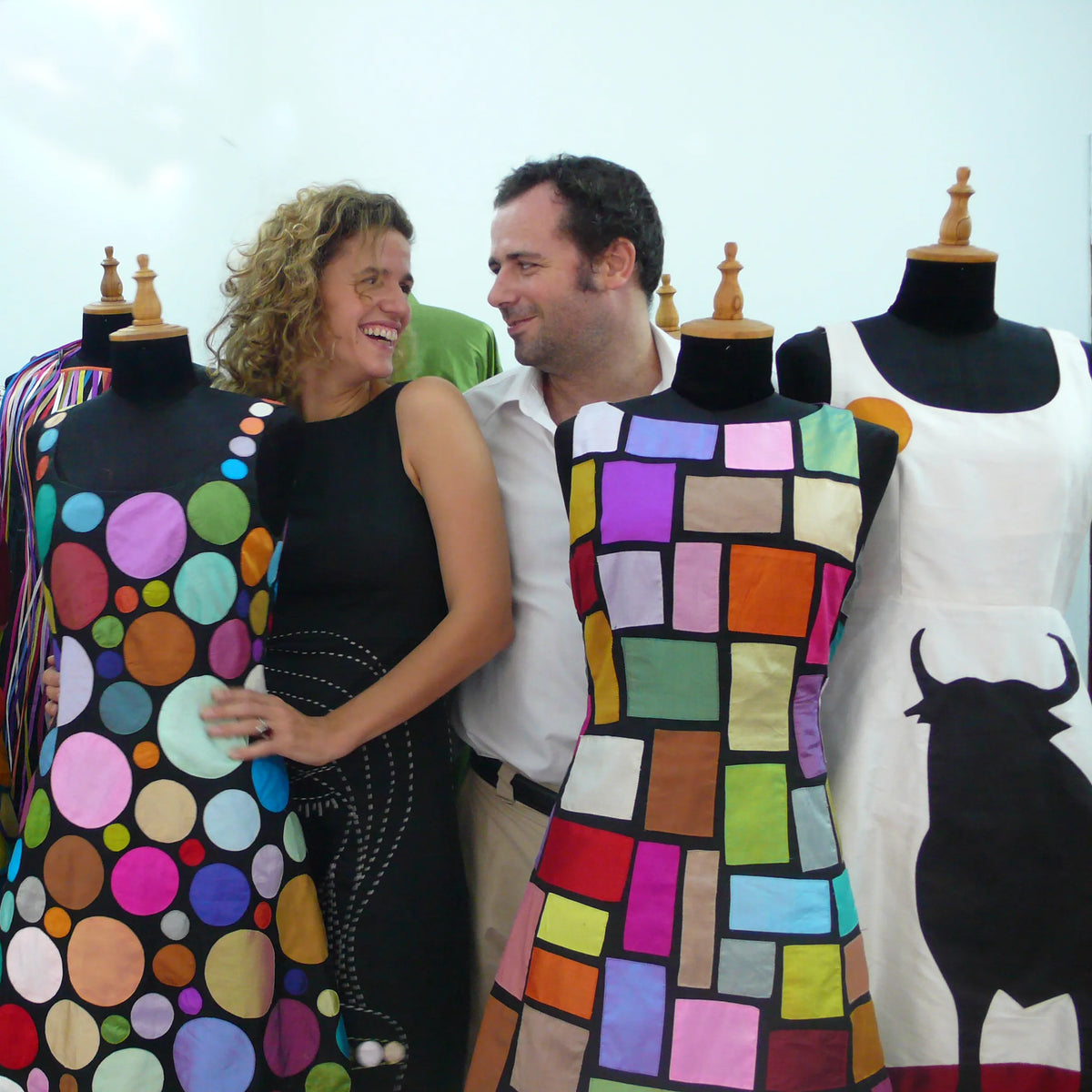 Laura Fontan and Diego Cortizas between dress stands in their first Chula pieces