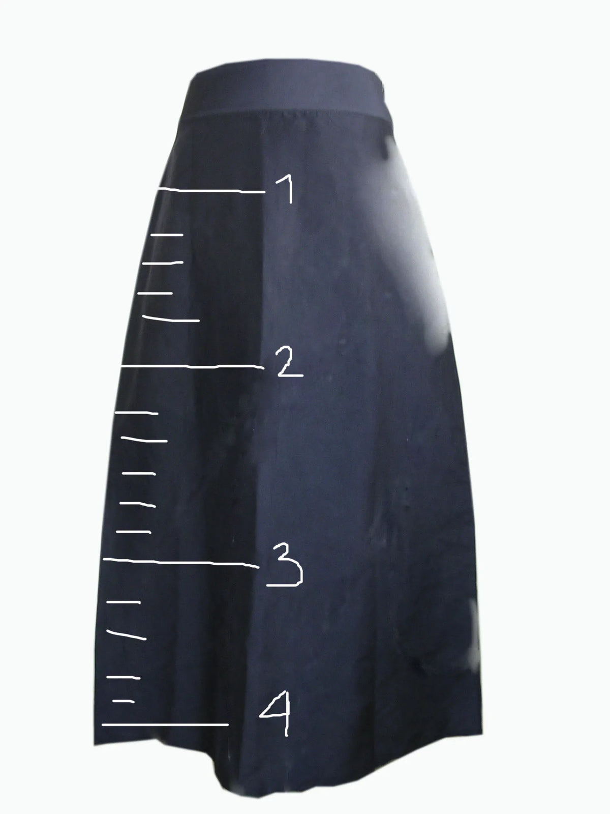 Navy skirt drawn in white line with a ruler and numbers, an early design